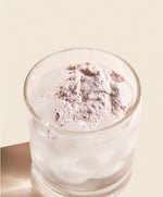 glass of water with powder on top