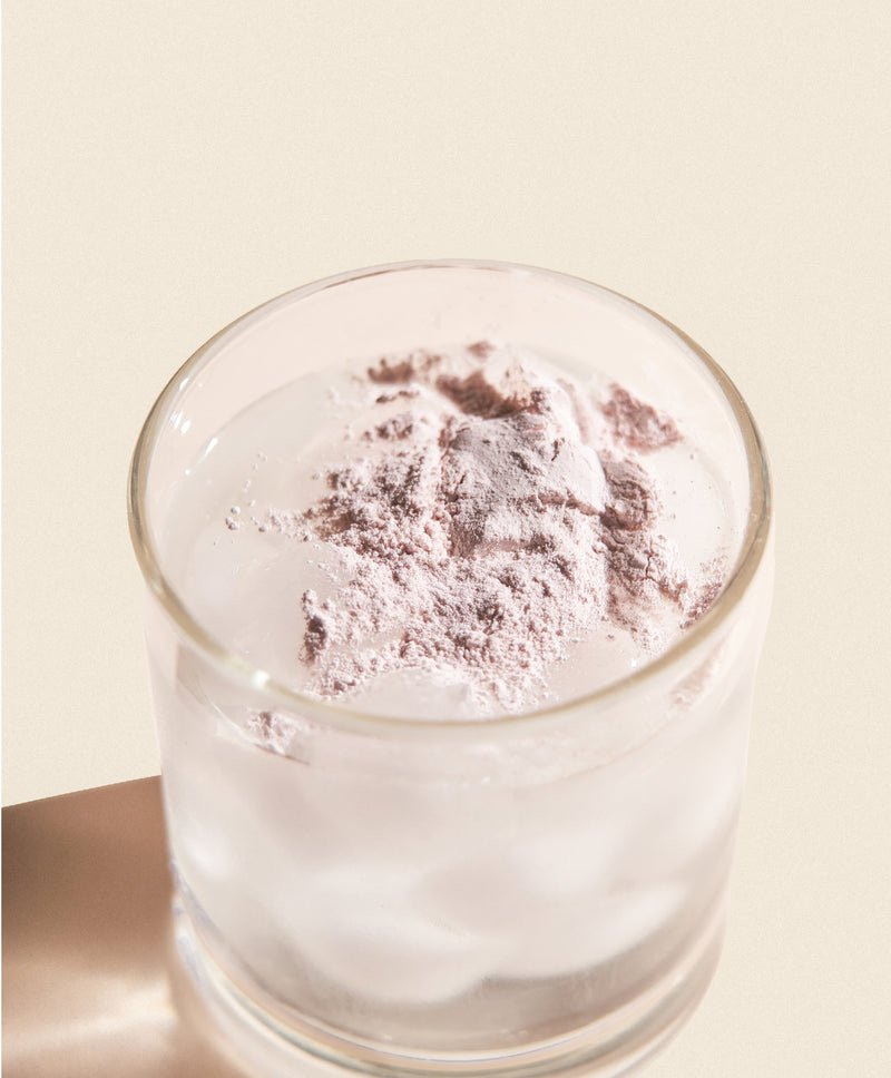 glass of water with powder on top