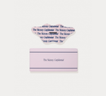 A pink rectangular box with a clear plastic lid, both printed with the text 'The Skinny Confidential', shown on a light gray background.