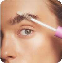 Eyebrow grooming with brush close-up