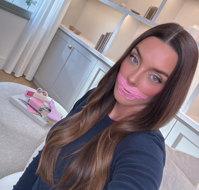 Woman with pink lip mask at home.