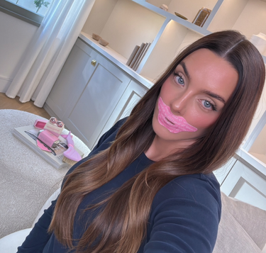 Woman with pink lip mask at home.
